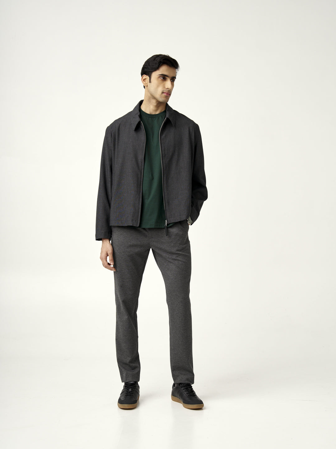 model showcasing charcoal pants paired with a green shirt by the Pant Project