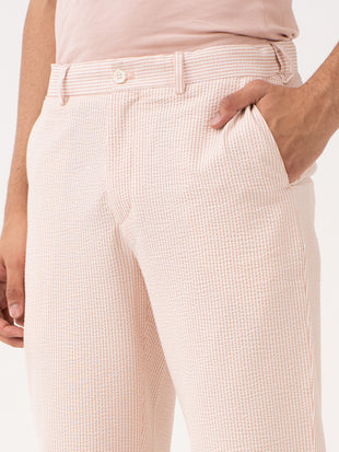 Poppy peach trousers by pant project, showcasing sleek design and comfortable fit, ideal for versatile styling.