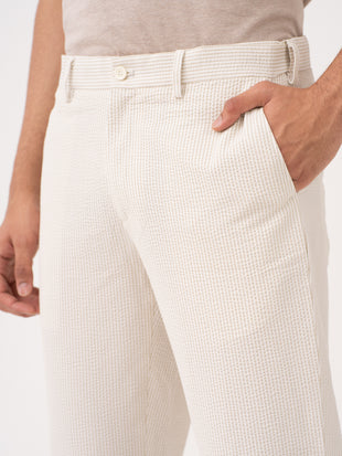 Milo beige tailored trousers by pant project, showcasing the sleek fit and premium fabric texture.
