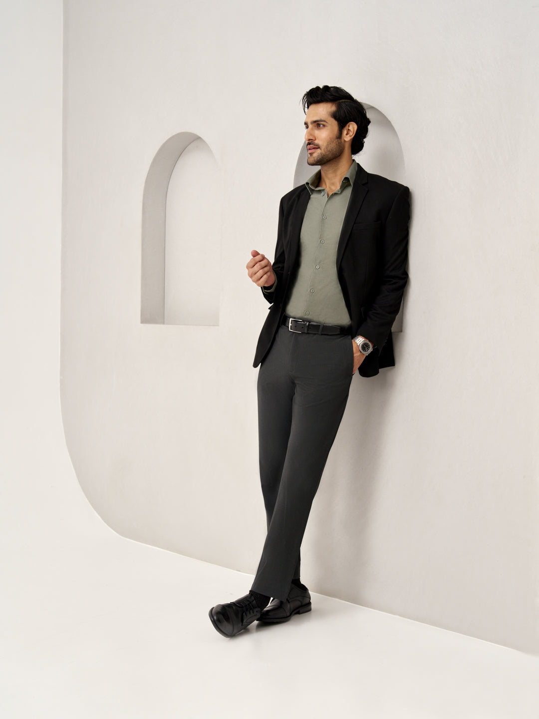 side view of model wearing Pant Project slate grey trousers, model wearing a watch