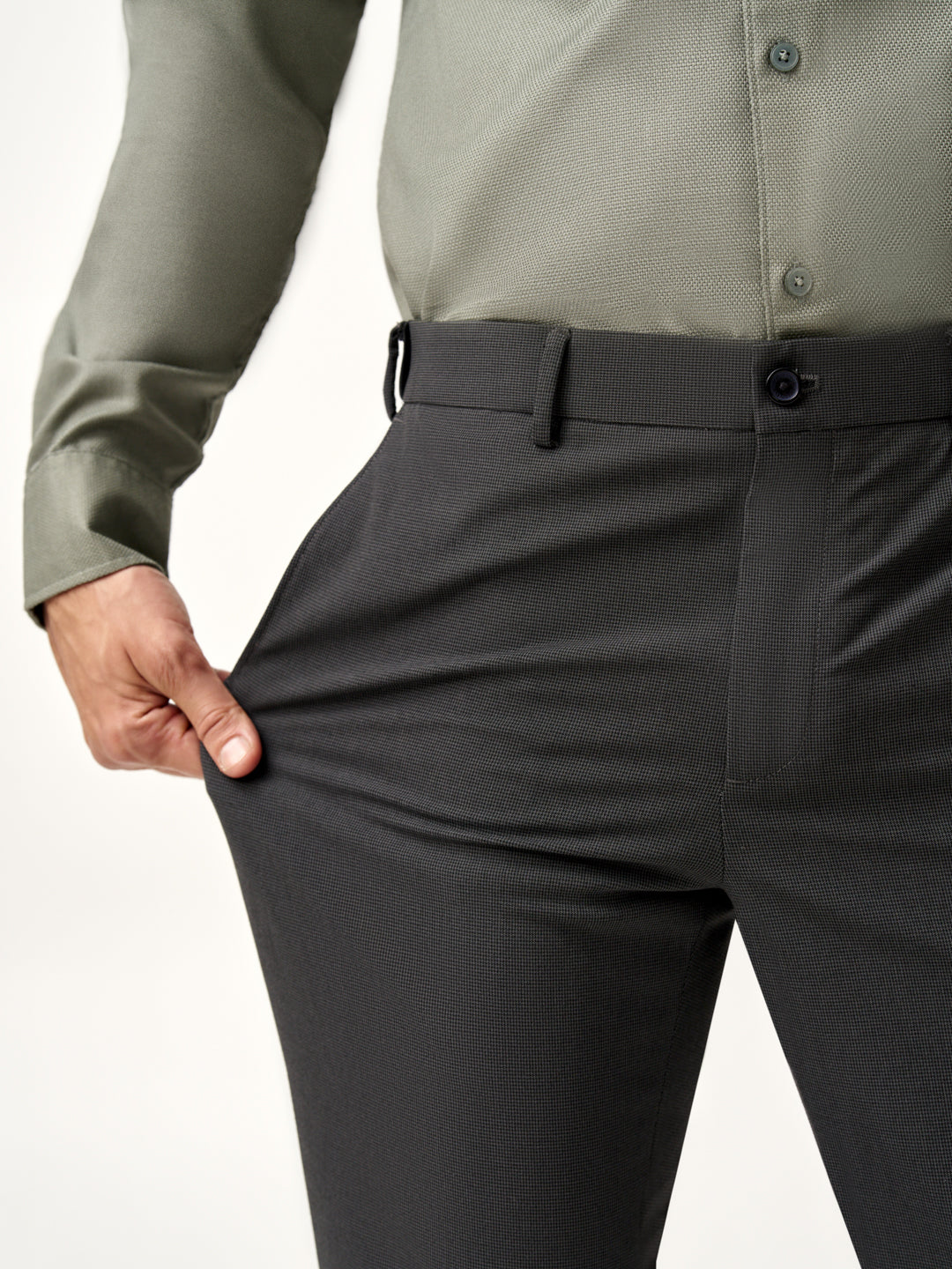model leaning against wall, full view of Pant Project slate grey trousers