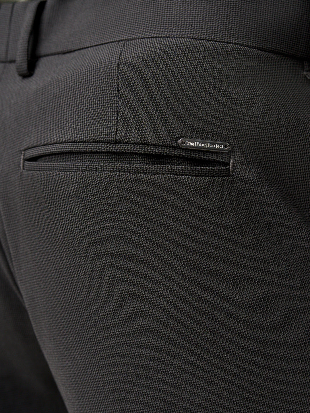 close view of button and waistband detail of the Pant Project slate grey stretch pants