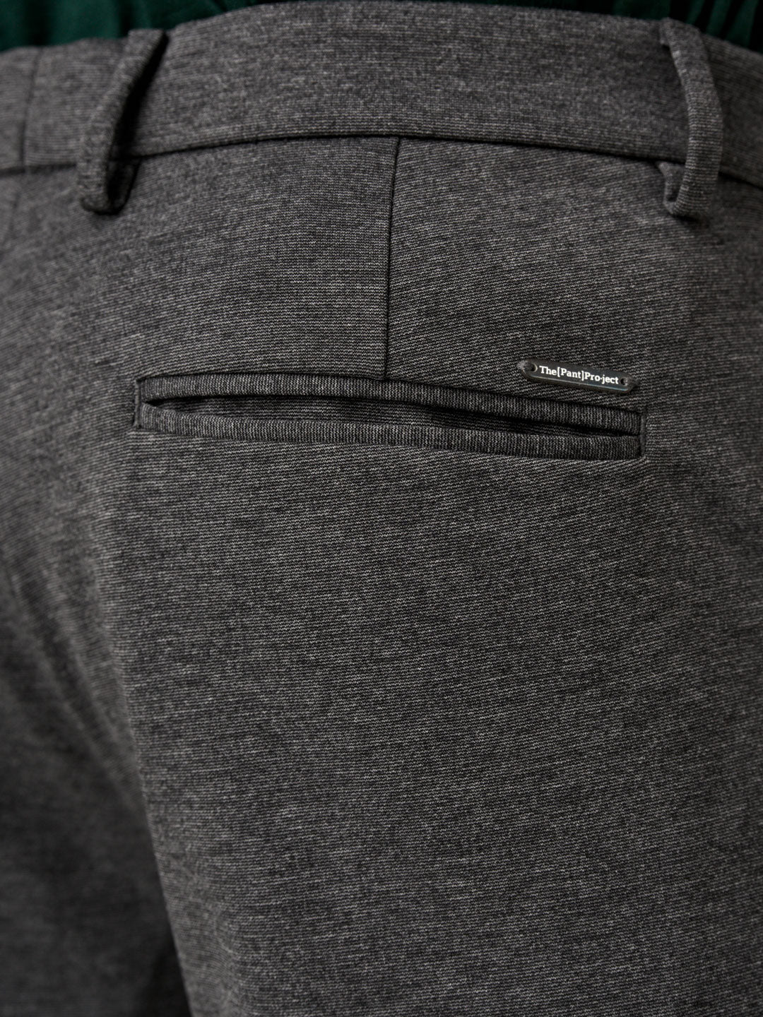 charcoal pants from the Pant Project paired with a green t-shirt and black sneakers