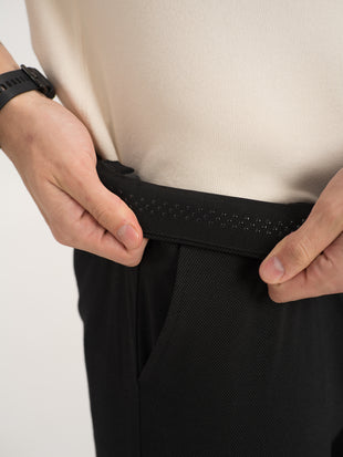 Close-up view of black stretchable trousers by pant project, focusing on the waistband detail