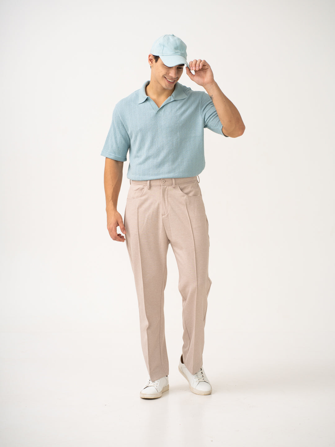 Full view of beige pintuck pants by pant project, focusing on the relaxed fit and straight leg design