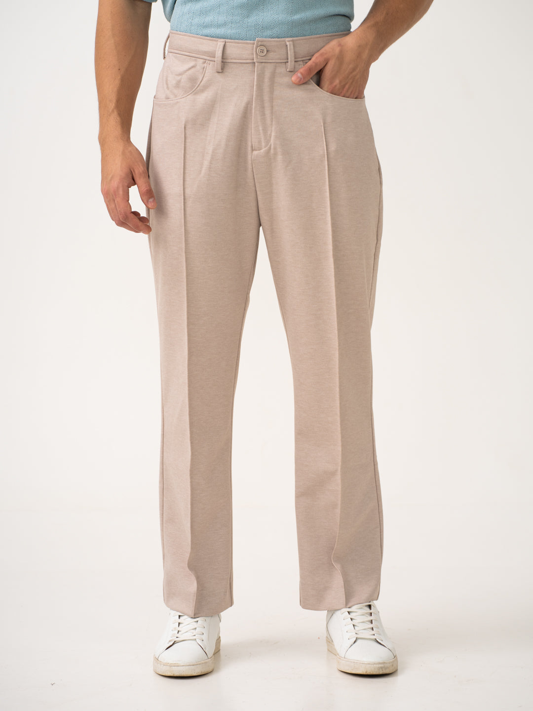Front view of beige pintuck pants by pant project, focusing on the pintuck design and relaxed fit