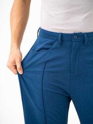 Close-up view of blue pintuck pants by pant project, focusing on the stretch of the waistband
