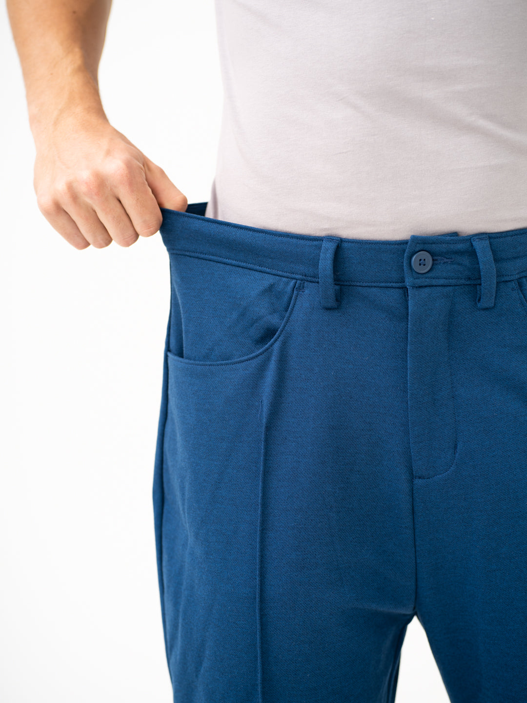 Close-up view of blue pintuck pants by pant project, focusing on the stretchable waistband