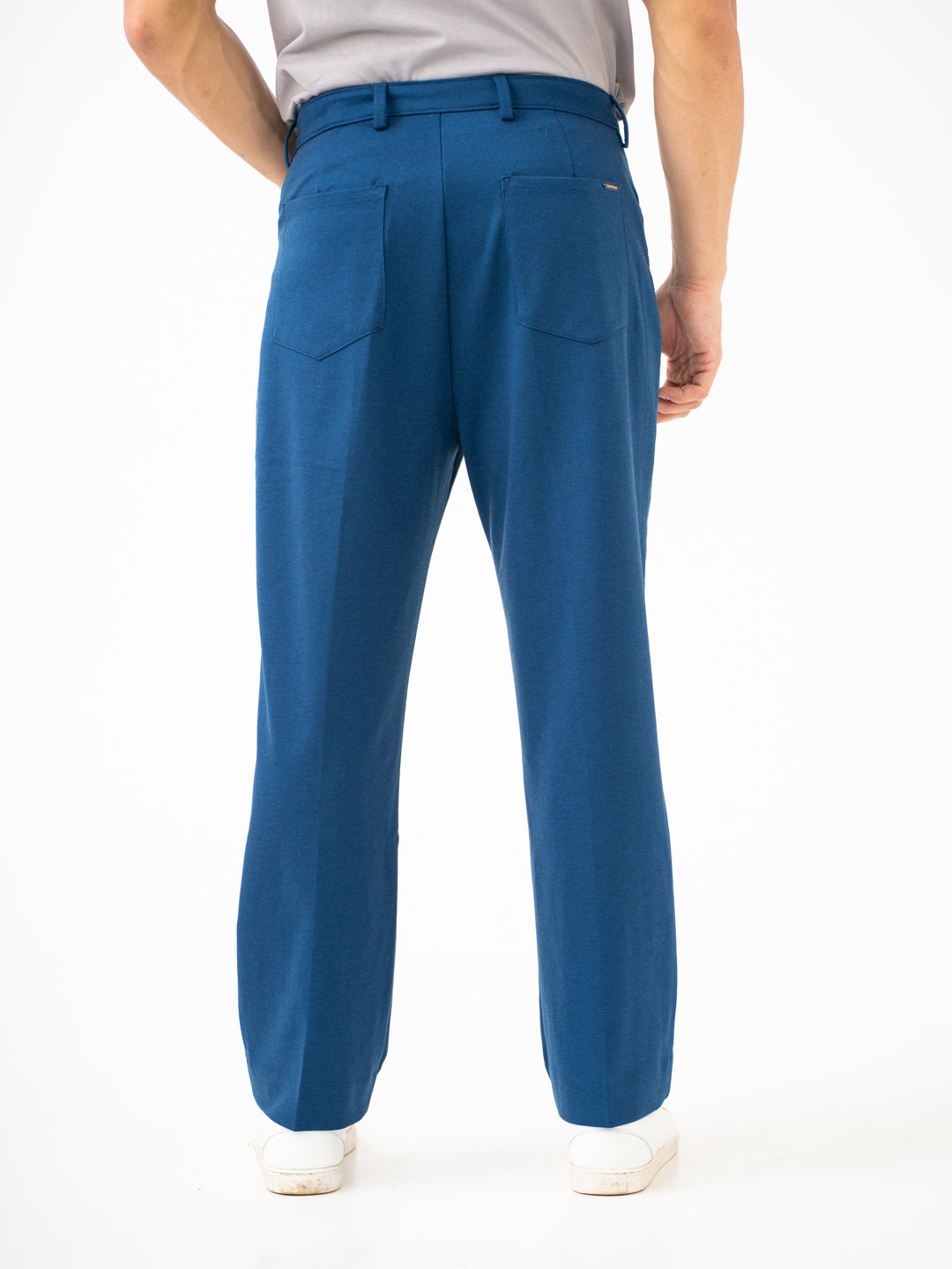 Rear view of blue pintuck pants by pant project, focusing on the back pockets and waistband