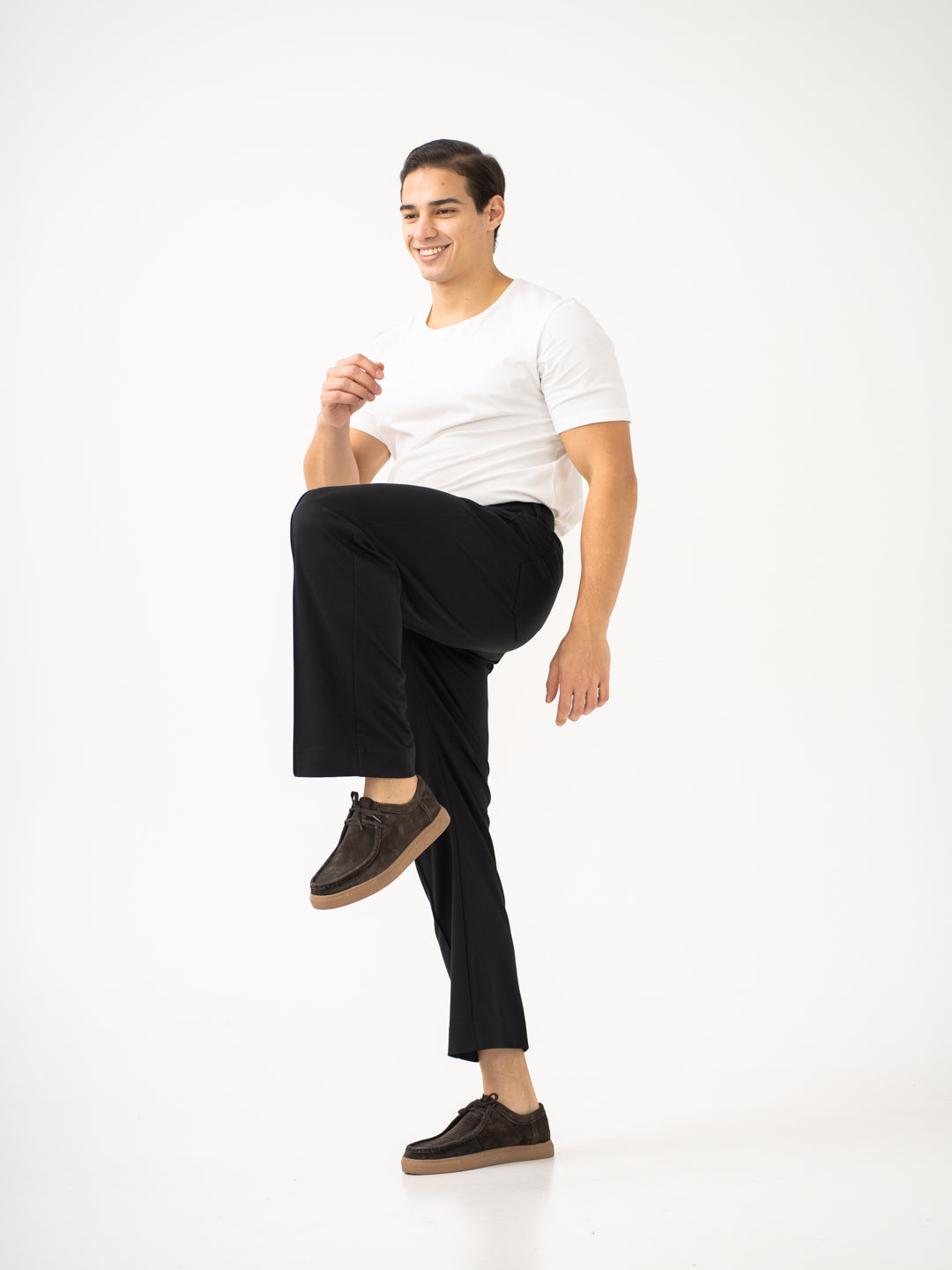 Full view of black pintuck pants by pant project, focusing on the relaxed fit and classic design