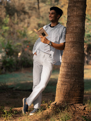Luna Grey Stripes Seersucker Pants by Pant Project, showcasing the elegant striped pattern and lightweight fabric in a lifestyle setting.