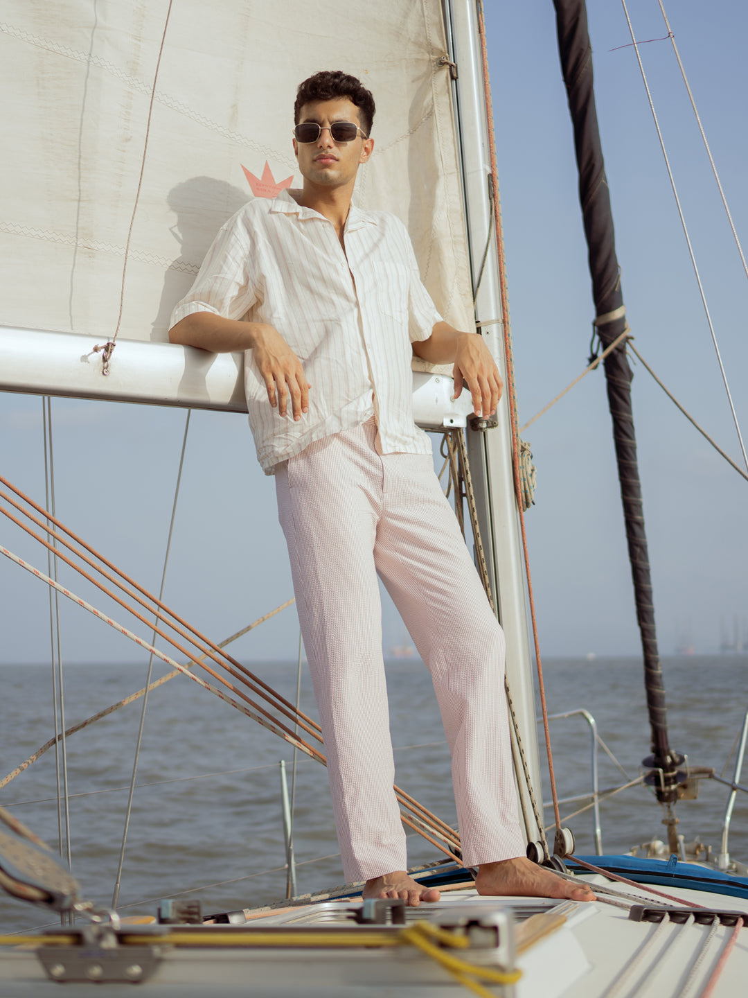 Romeo rouge stripes seersucker pants by pant project, showcasing red and white striped pattern in a lifestyle setting.
