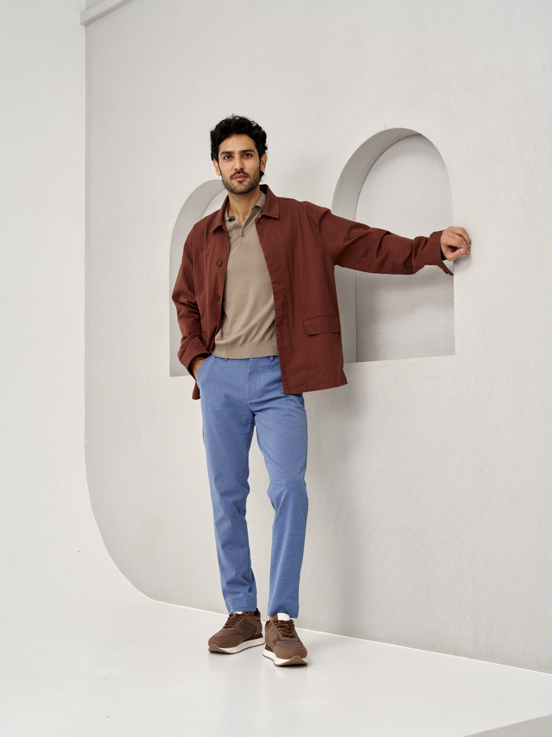 a man in brown jacket and beige polo, wearing ocean waves custom-fit pants by the Pant Project