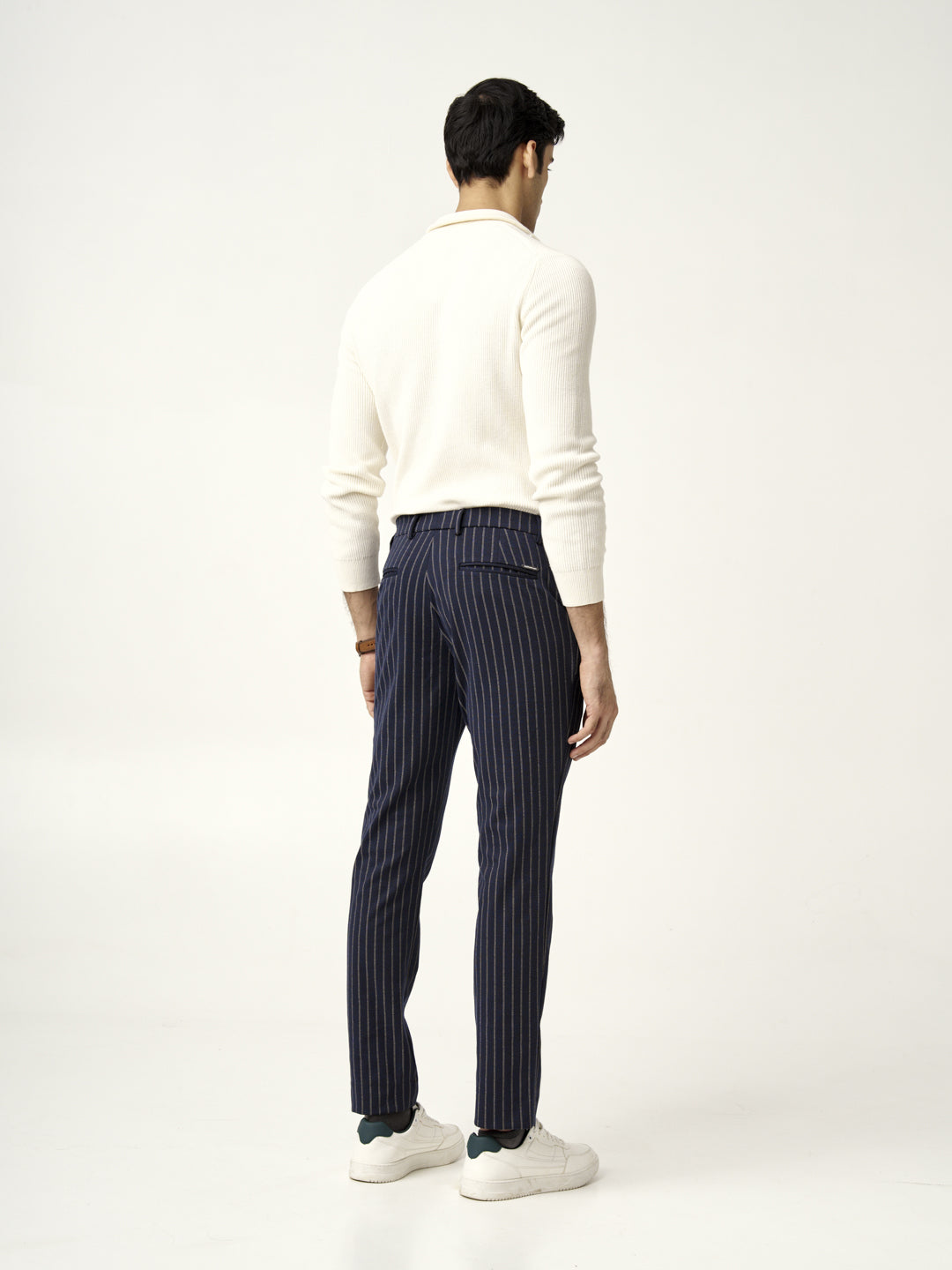 rear view of blue pinstripe pants with white sneakers, from the Pant Project collection