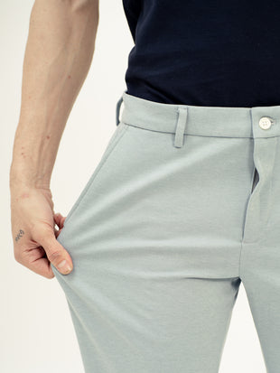 Close-up view of blue stretchable trousers by pant project, focusing on the stretch of the fabric