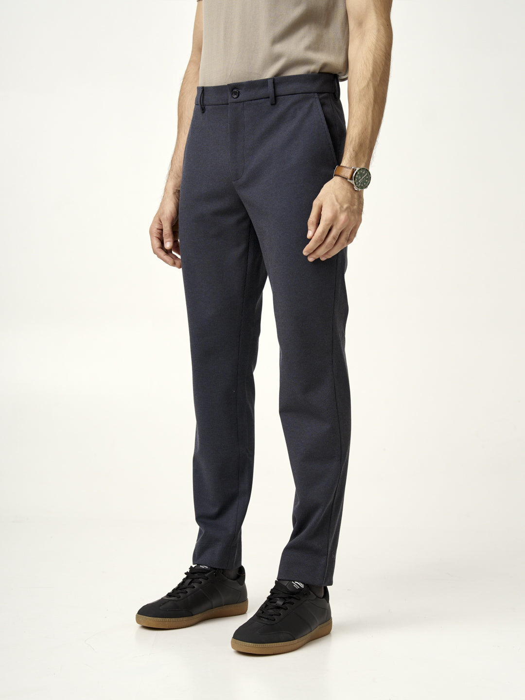 man standing in storm grey pants by the Pant Project with hands in pockets