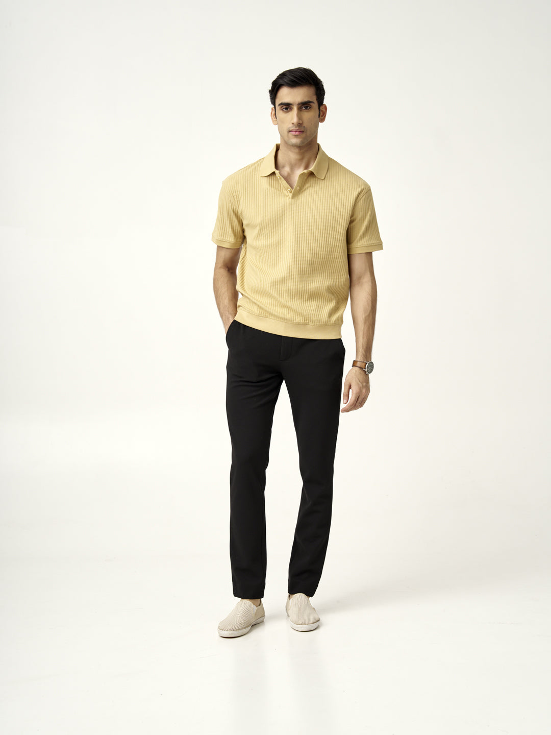 full front view of modern black texture pants from the Pant Project paired with a yellow polo shirt