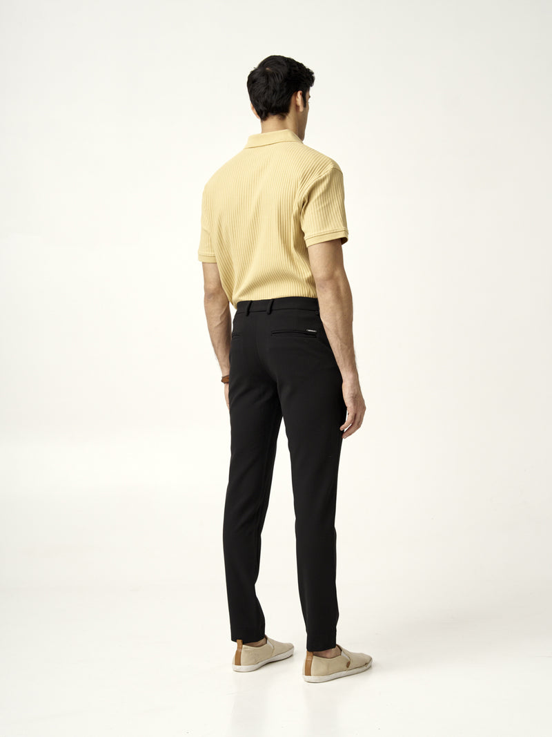 full front view of modern black texture pants paired with casual beige shoes from the Pant Project