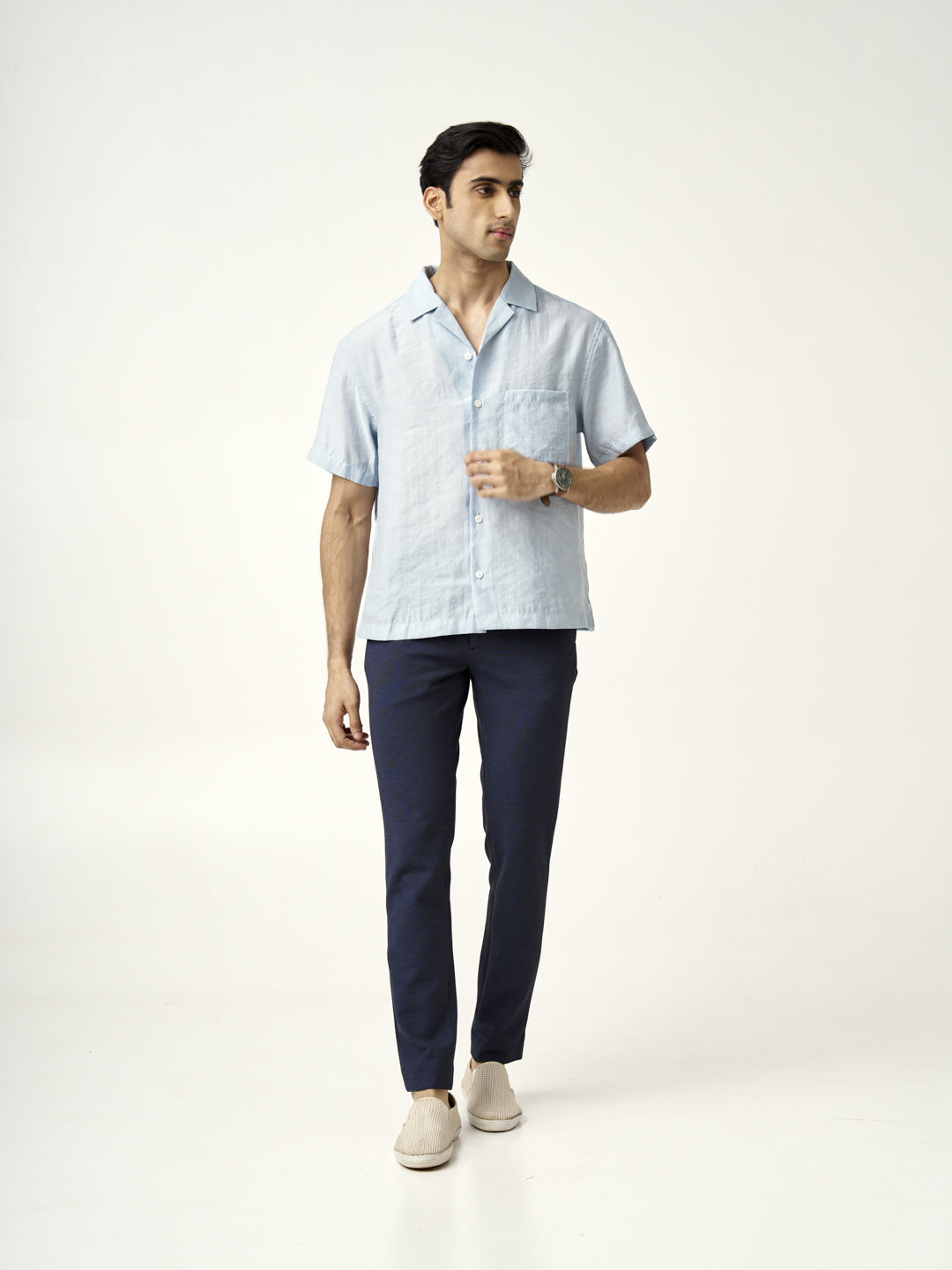A model in sail blue pants by the Pant Project, paired with a light blue shirt