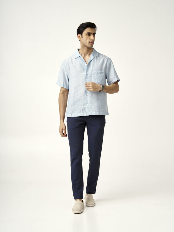 A model in sail blue pants by the Pant Project, paired with a light blue shirt
