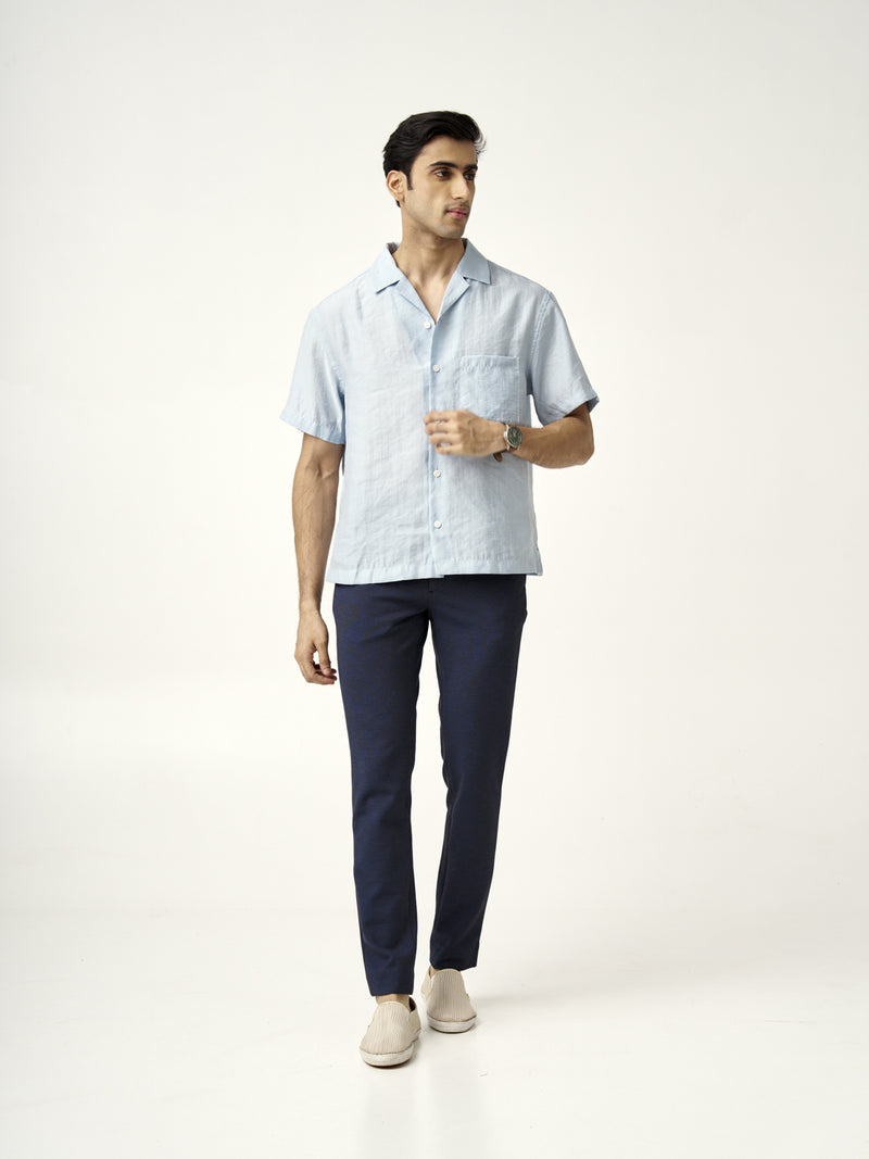 A model in sail blue pants by the Pant Project, paired with a light blue shirt