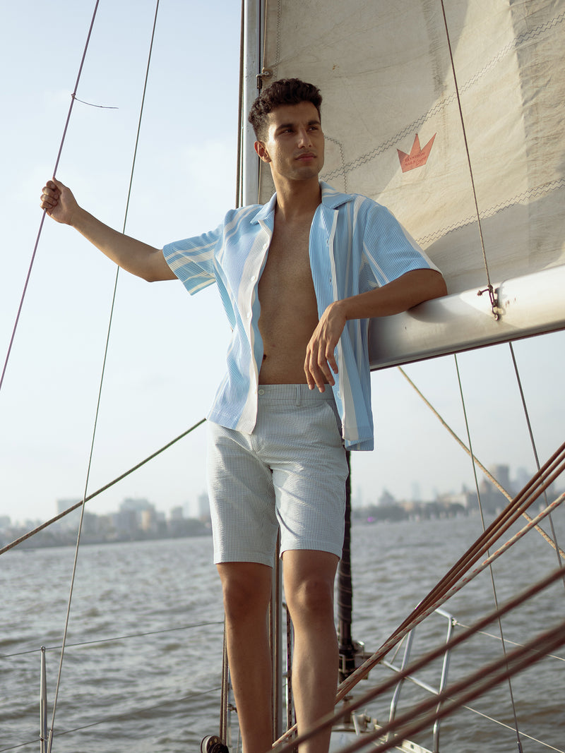 Lifestyle image of captain navy blue stripes seersucker chino shorts by pant project, showcasing the striped pattern and lightweight fabric.