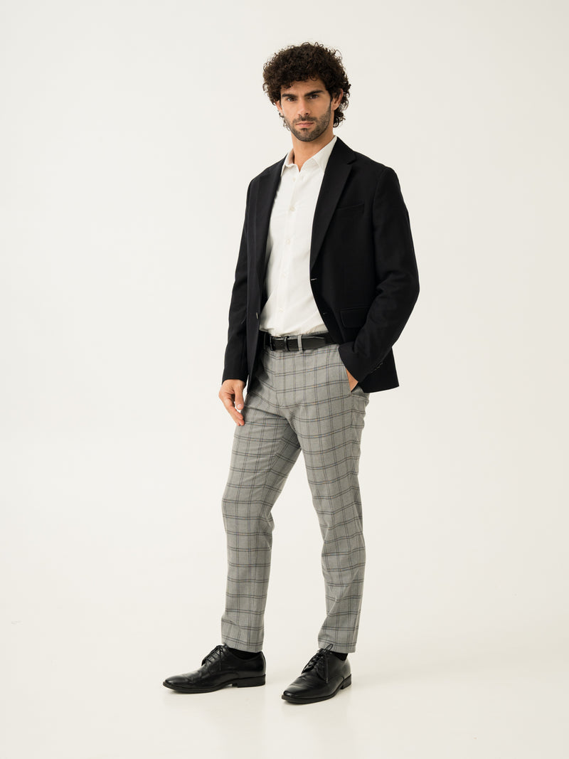 Side full view of grey big checkered slim fit stretch formal pant at Pant Project