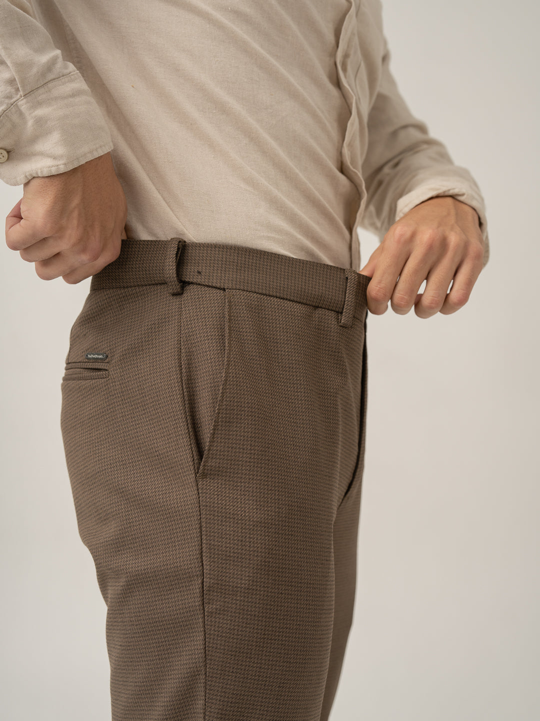 Stretch waistband close up of acon brown textured formal pant at Pant Project