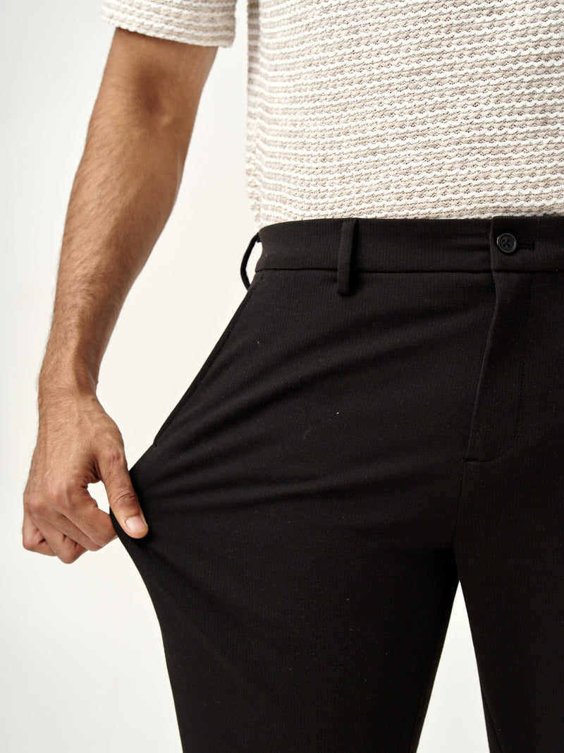 man wearing black stretch pants from the Pant Project, product name double bloodstood