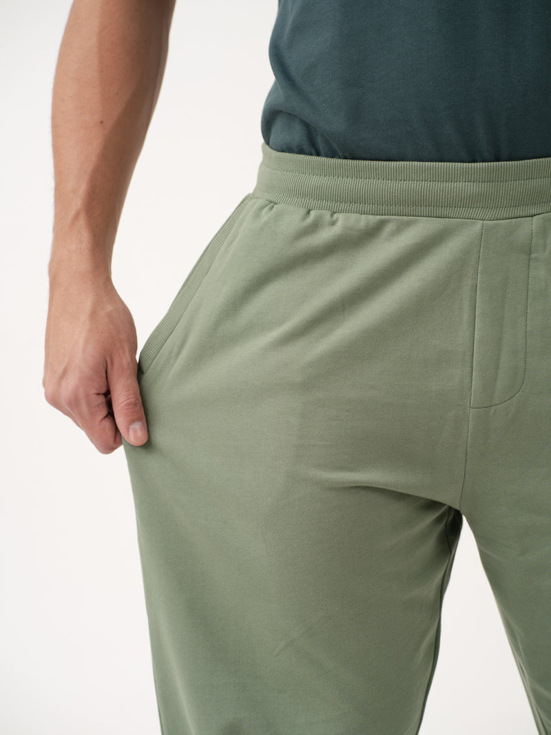 close-up front view of green sweatpant by pant project with ribbed waistband