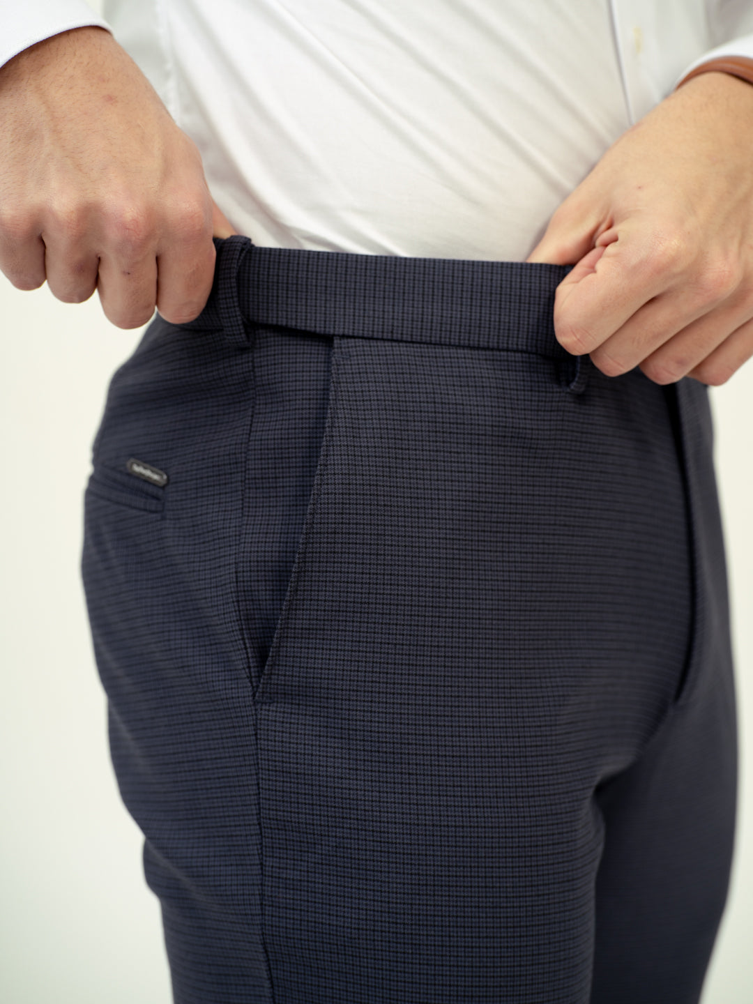 close-up side view of flint grey check pant by pant project showing textured fabric