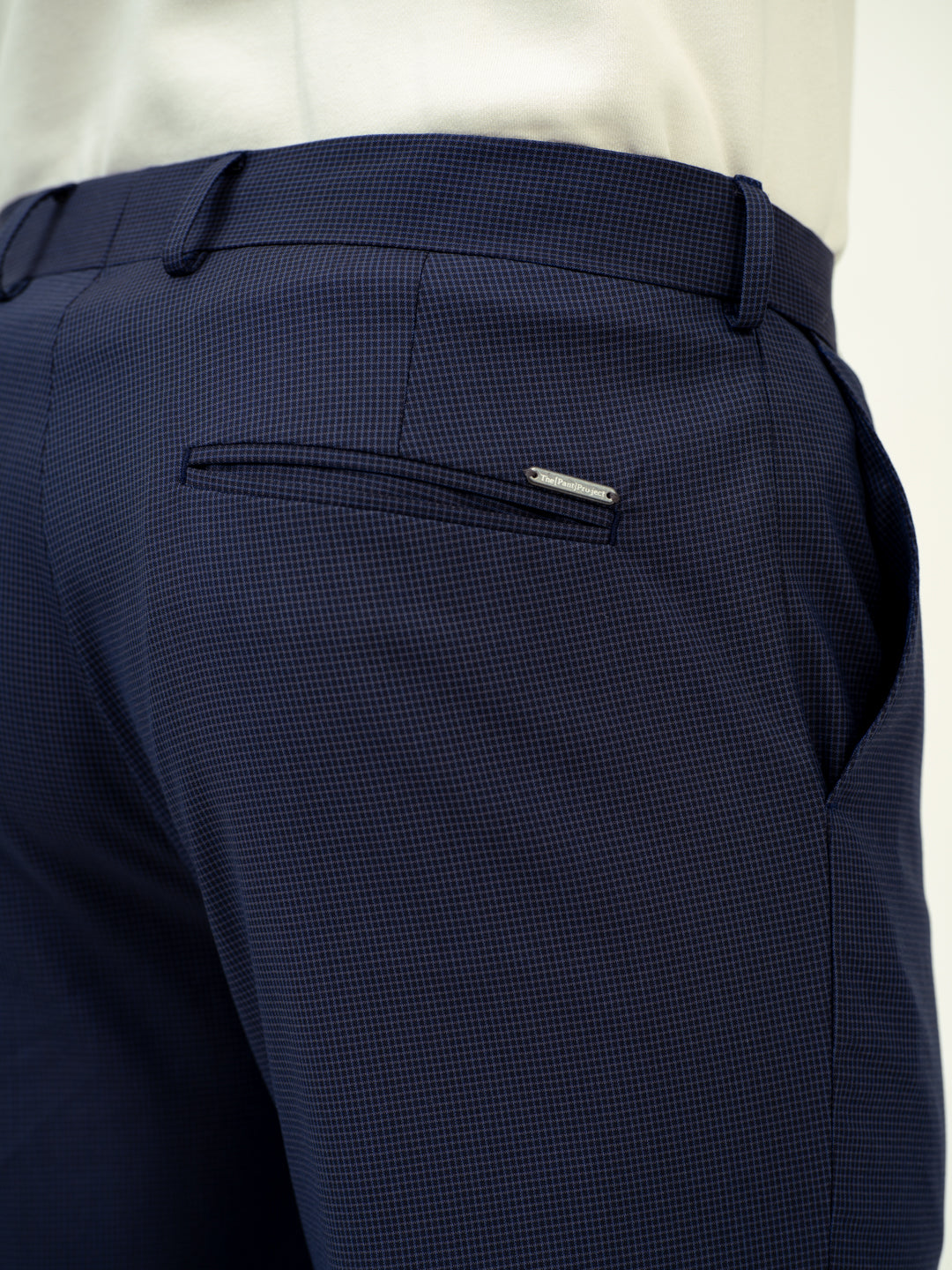 close-up back view of navy check pant by pant project showing pocket detail