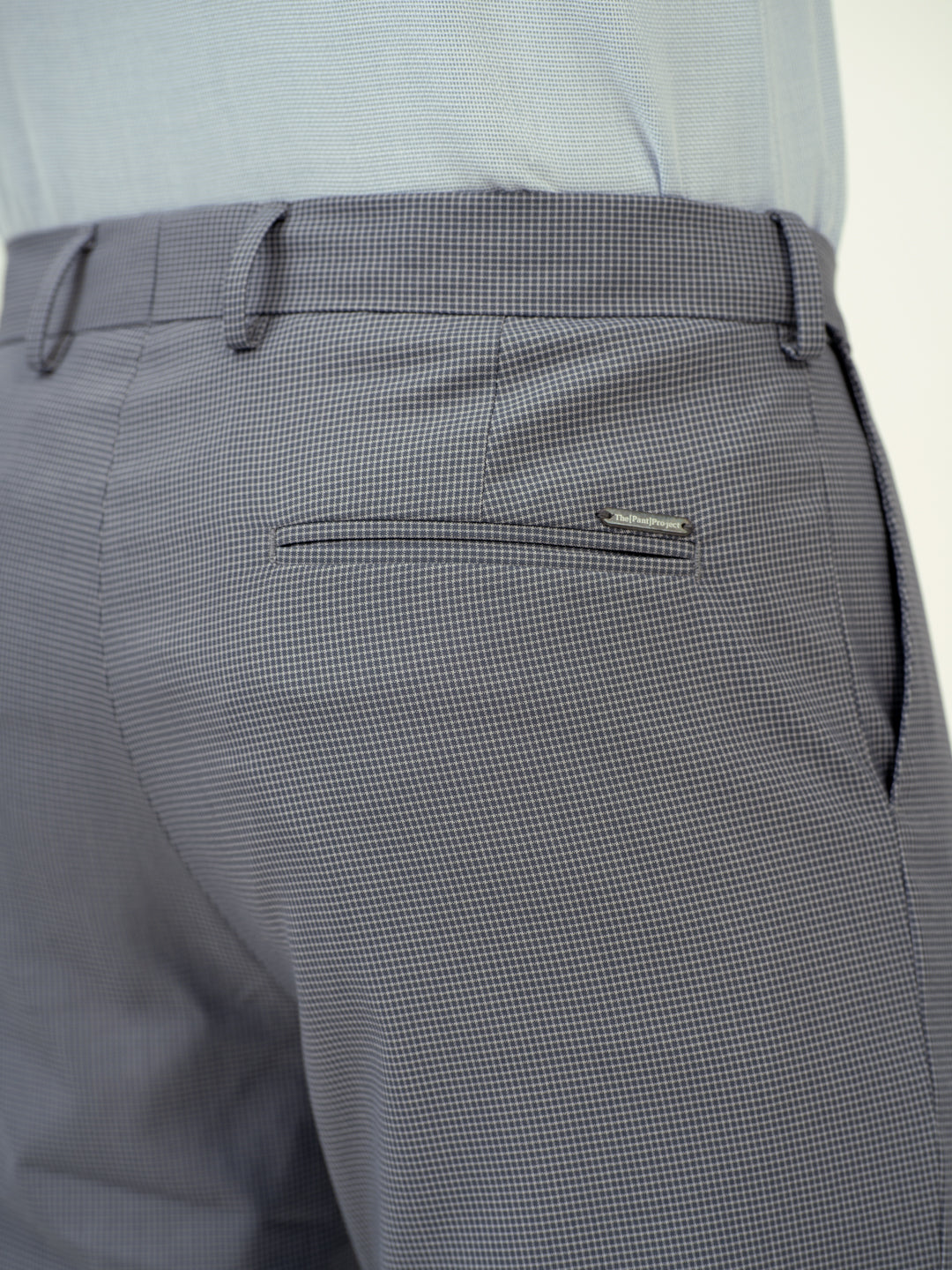 close-up back view of grey checkered pant by pant project showing pocket detail