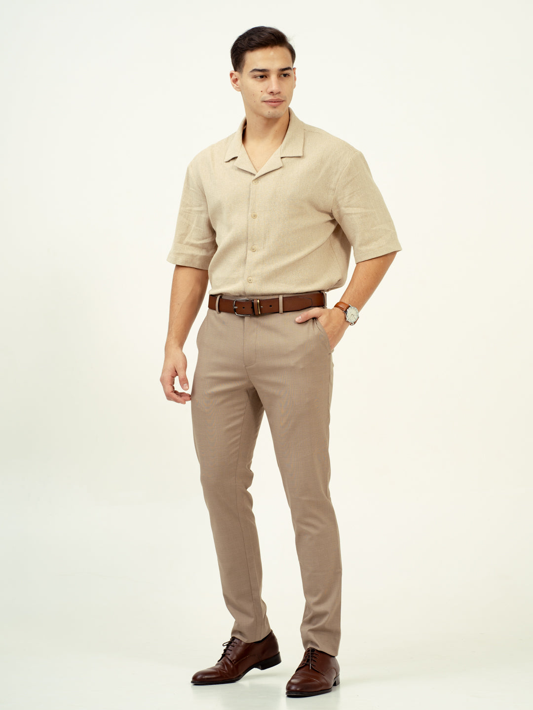 front view of tiramisu beige pants by pant project with blue shirt and brown shoes