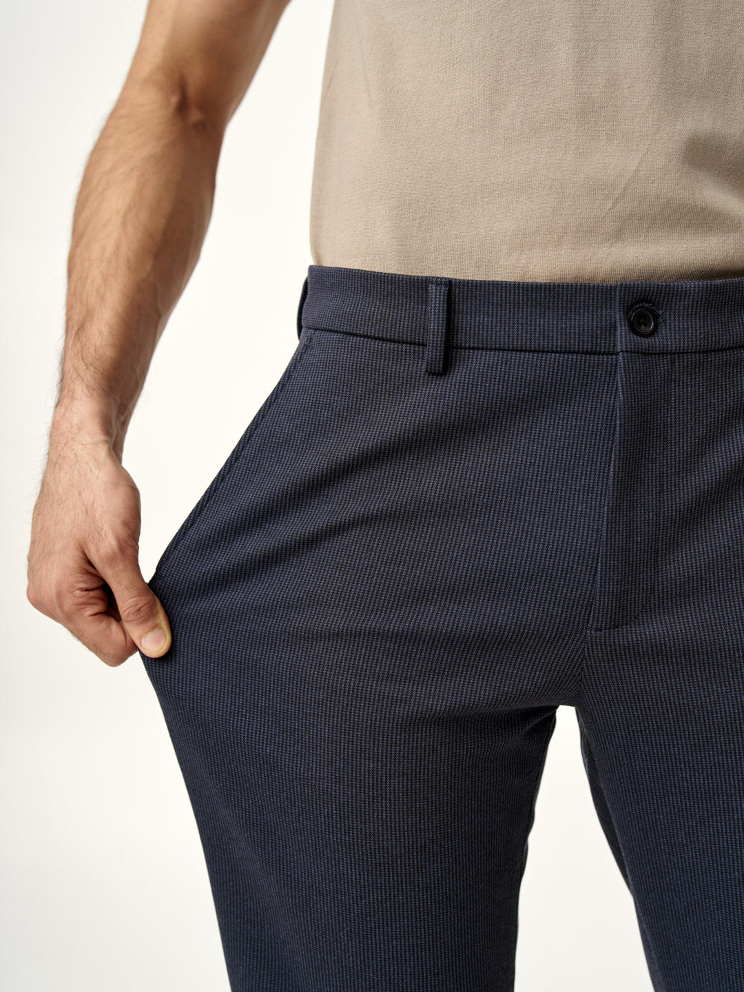 model wearing slim-fit storm grey pants by the Pant Project paired with a beige polo