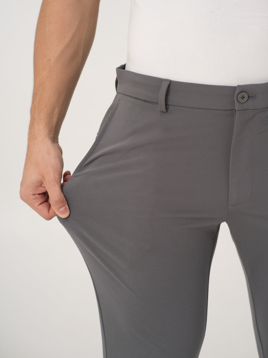 Close-up view of grey stretchable trousers by pant project, focusing on the waistband and pocket detail