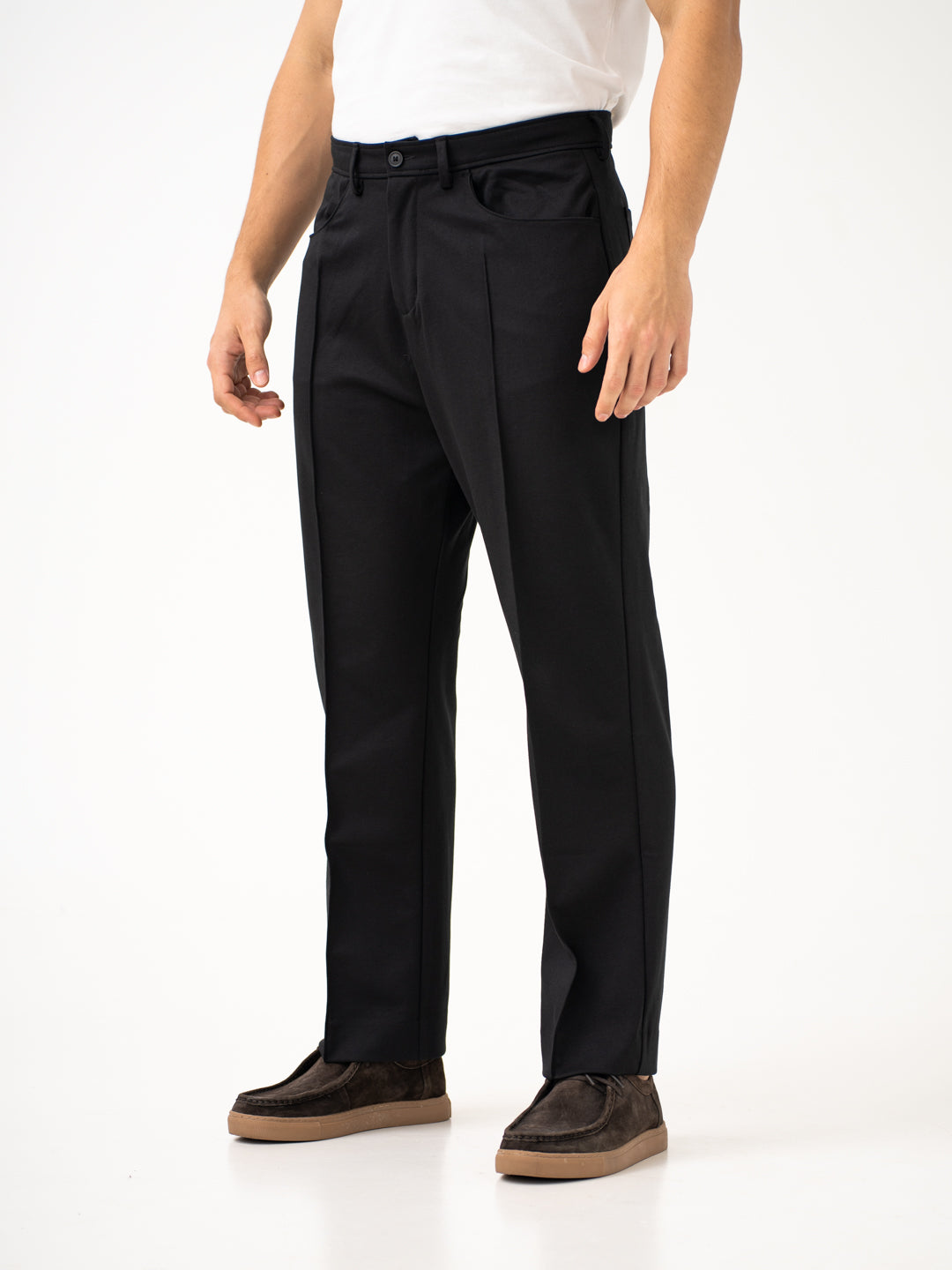 Front view of black pintuck pants by pant project, focusing on the relaxed fit and side pockets