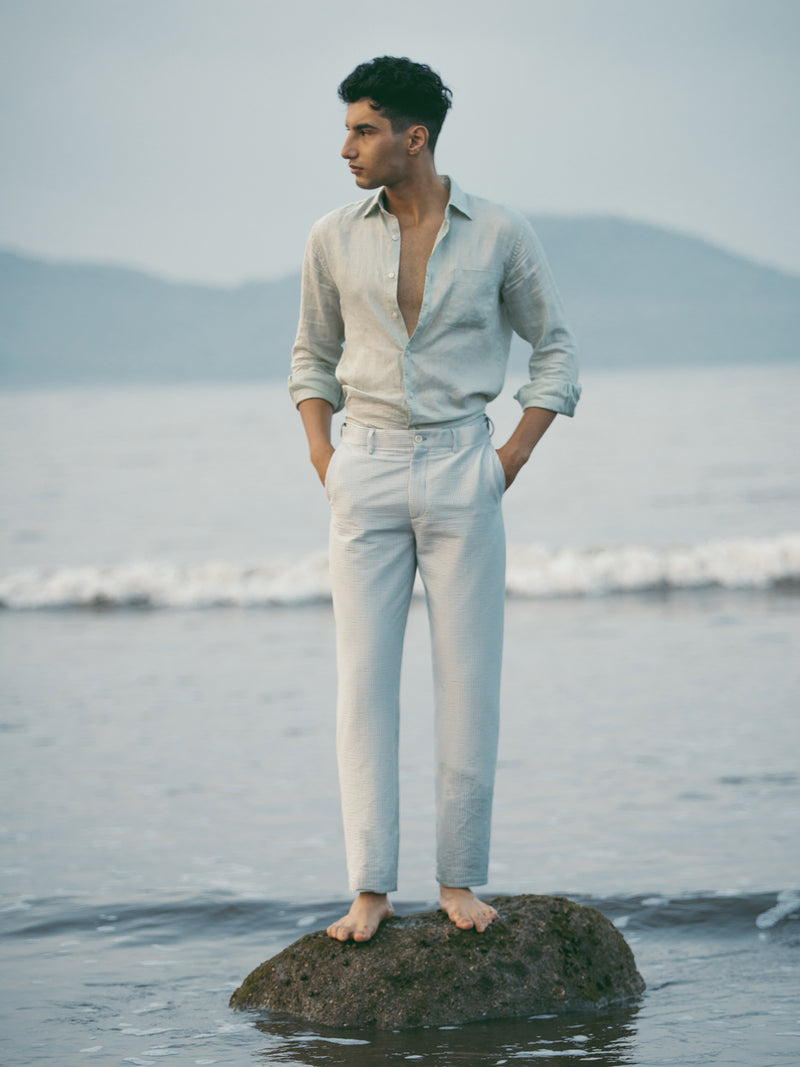 Meadow green stripes seersucker chino shorts by pant project, showcasing lightweight fabric and classic stripe design in an outdoor setting.