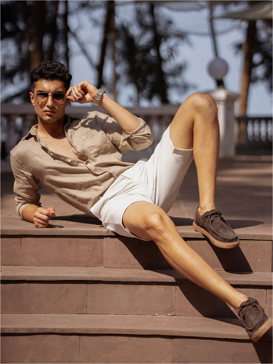 Lifestyle image of milo beige stripes seersucker chino shorts by pant project, showcasing the lightweight, textured fabric in a casual setting.