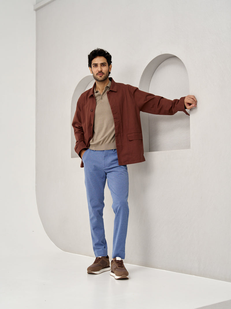 a man in brown jacket and beige polo, wearing ocean waves custom-fit pants by the Pant Project