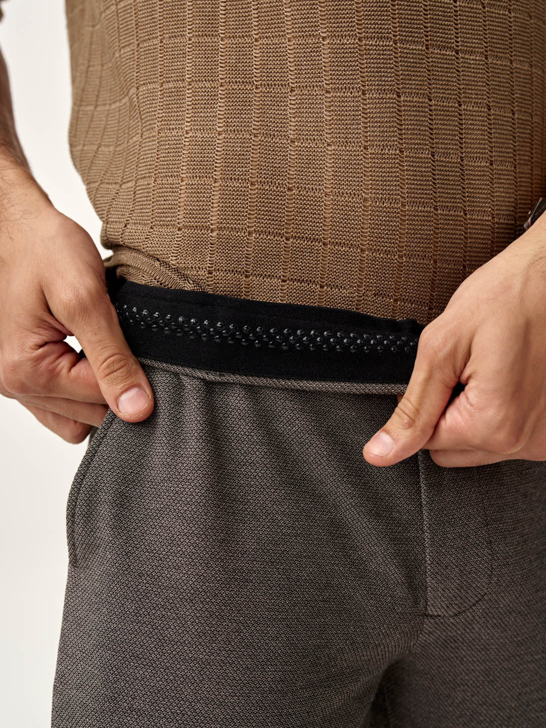 adjusting the comfortable elastic waistband of granite texture pants from the Pant Project