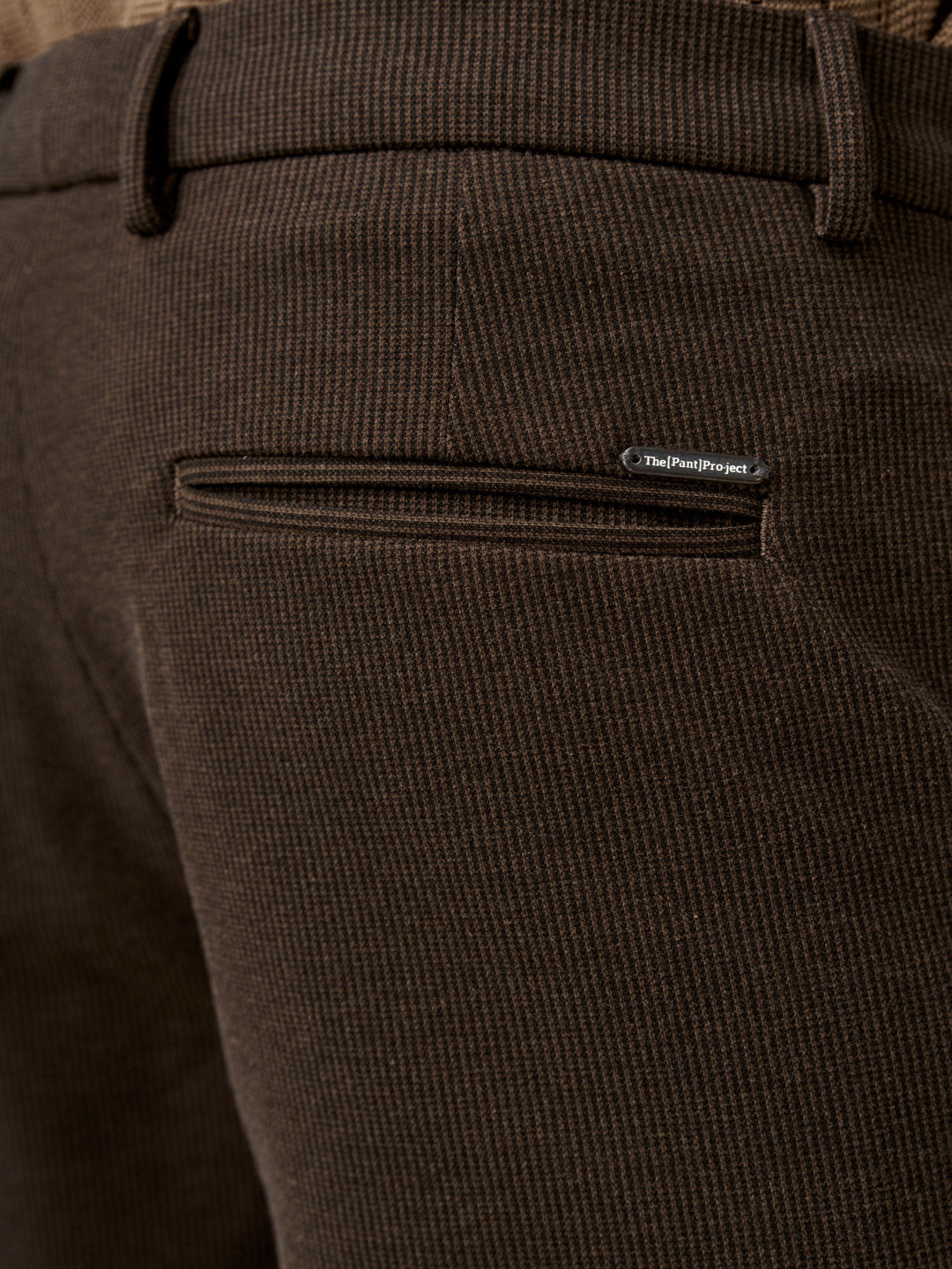 back pocket detail of the walnut brown pants with logo badge from the Pant Project