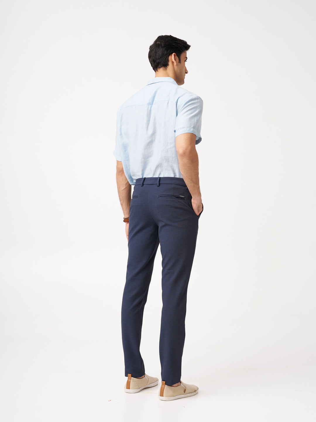 back view of man wearing the Pant Project sail blue pants with a light blue shirt