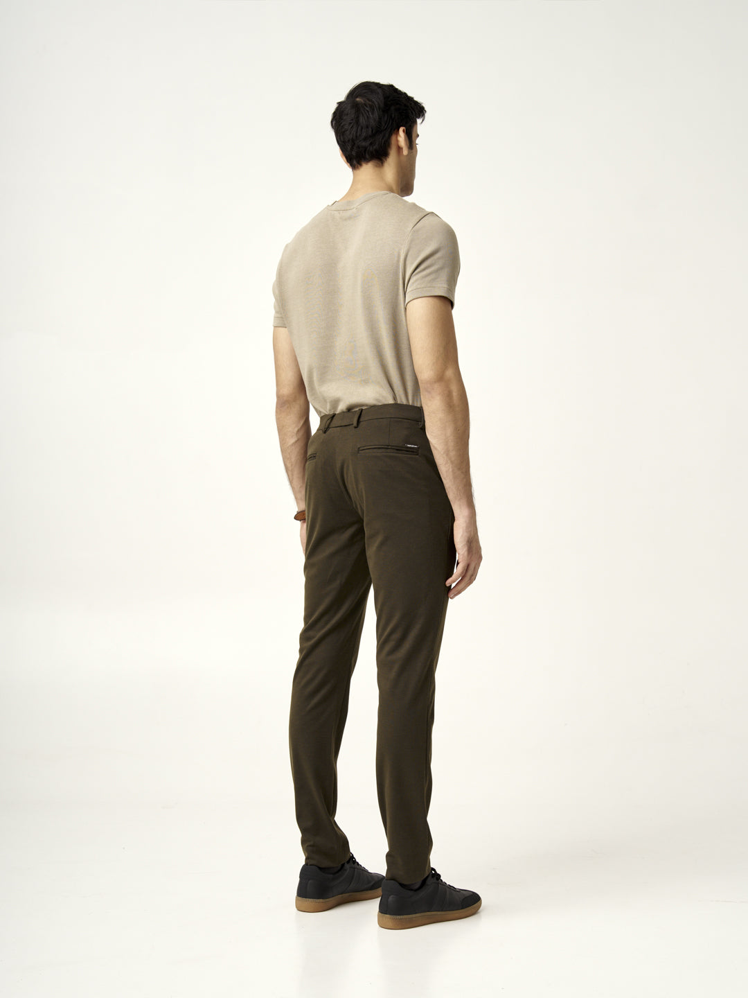 back view of martini olive pants styled with a beige t-shirt by the Pant Project