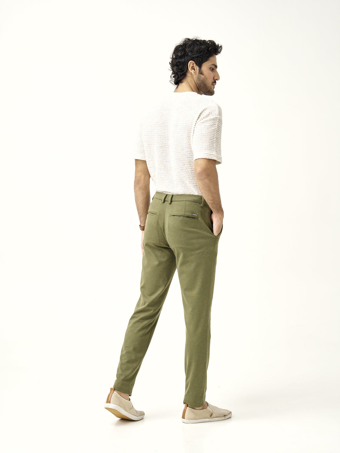 back view of military green pants by the Pant Project paired with casual white top
