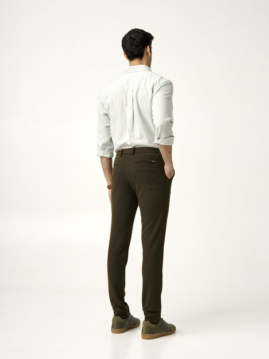 back view of olive textured pants paired with light green shirt by the Pant Project