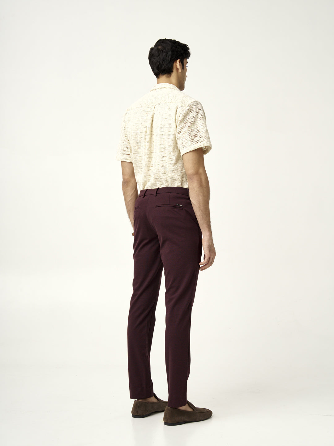 back view of plum wine pants from the Pant Project paired with a cream knitted shirt
