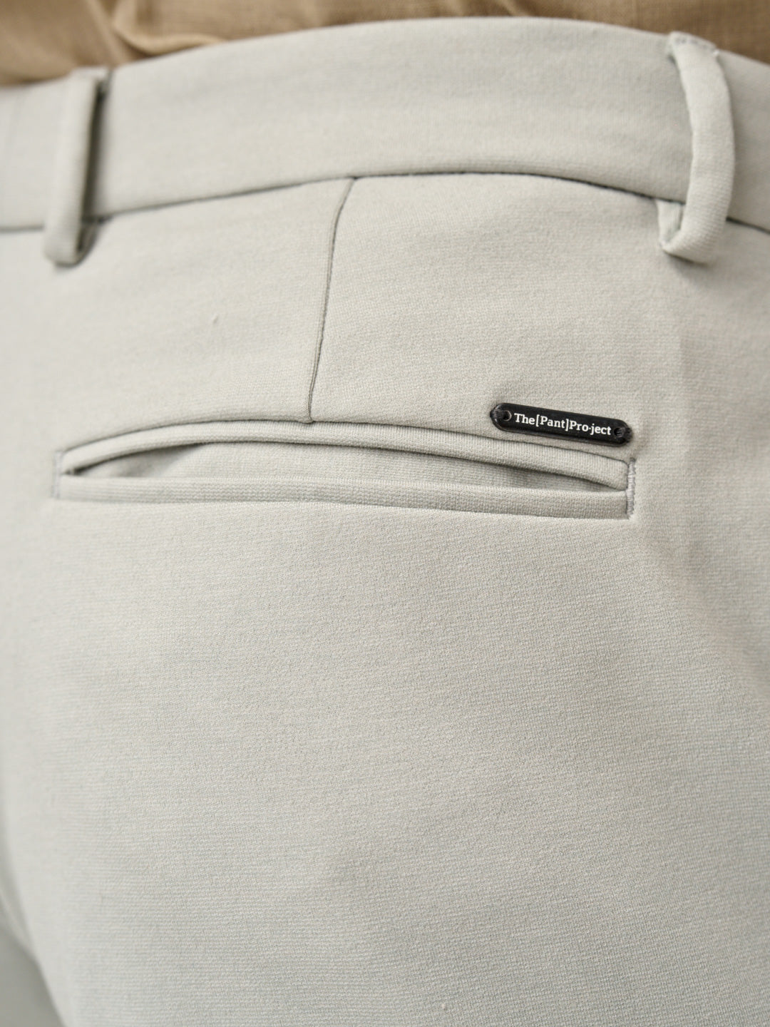 close-up of back pocket and logo detail on matcha green pants by the Pant Project