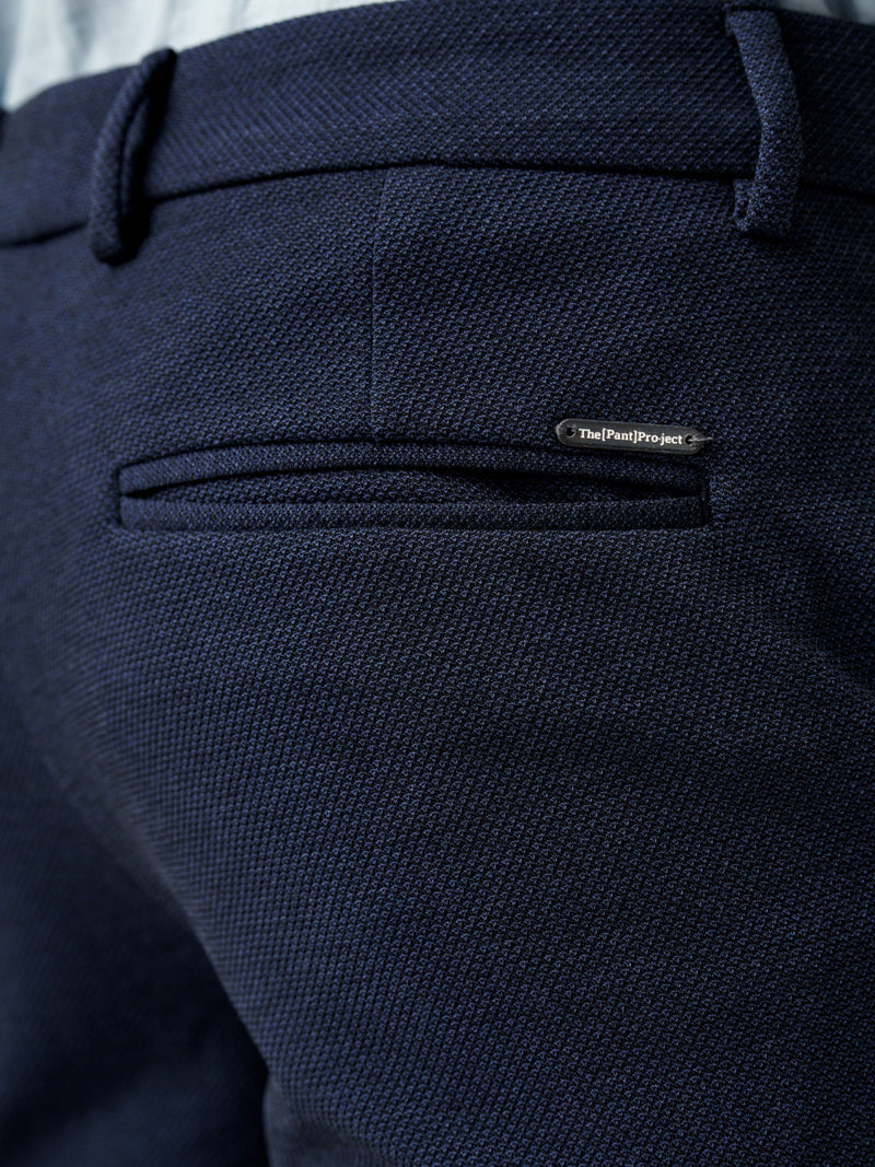 close-up of back pocket with the Pant Project label on sail blue pants