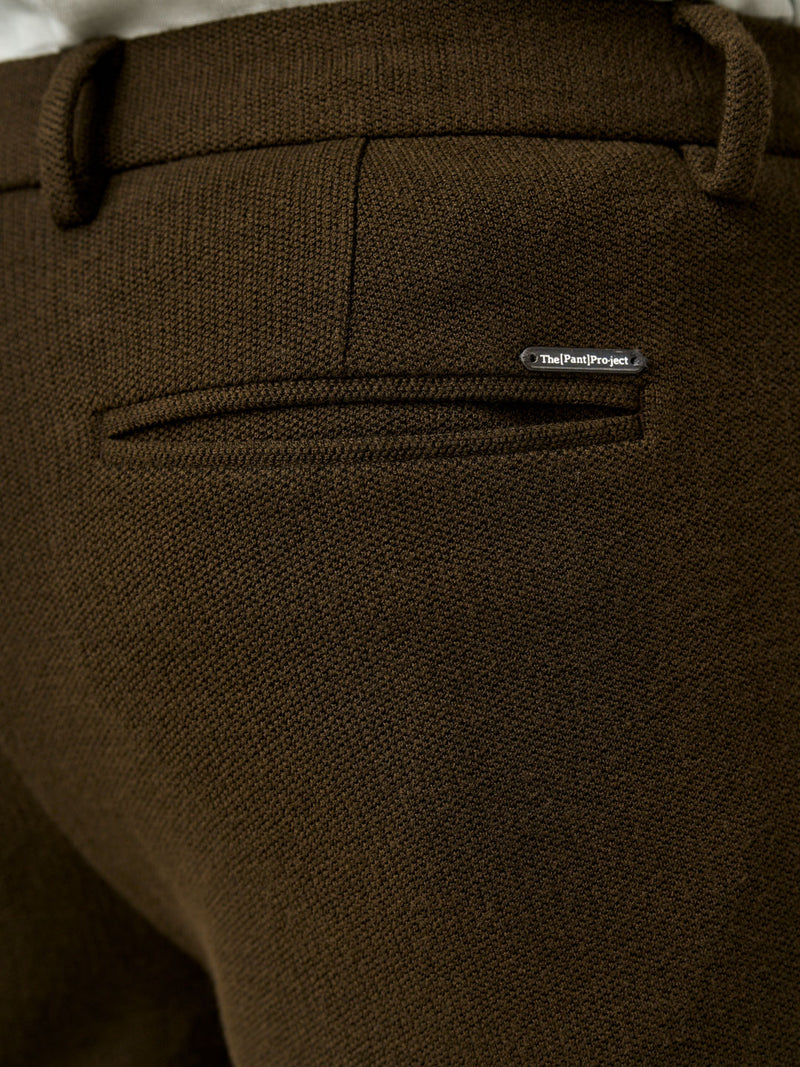 close-up of brown textured pants with the Pant Project label near the back pocket